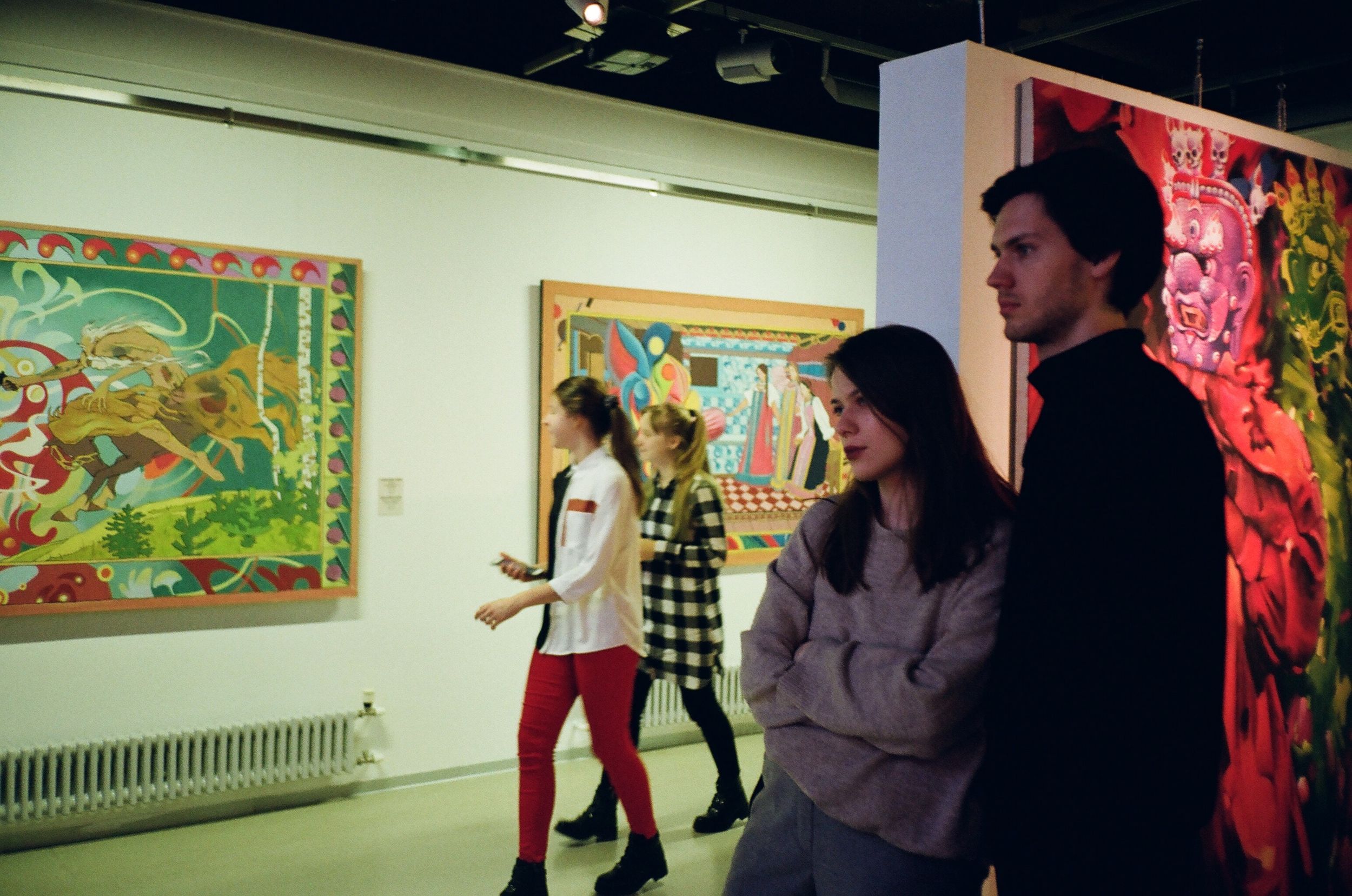 Two people enjoy modern artwork in a museum.