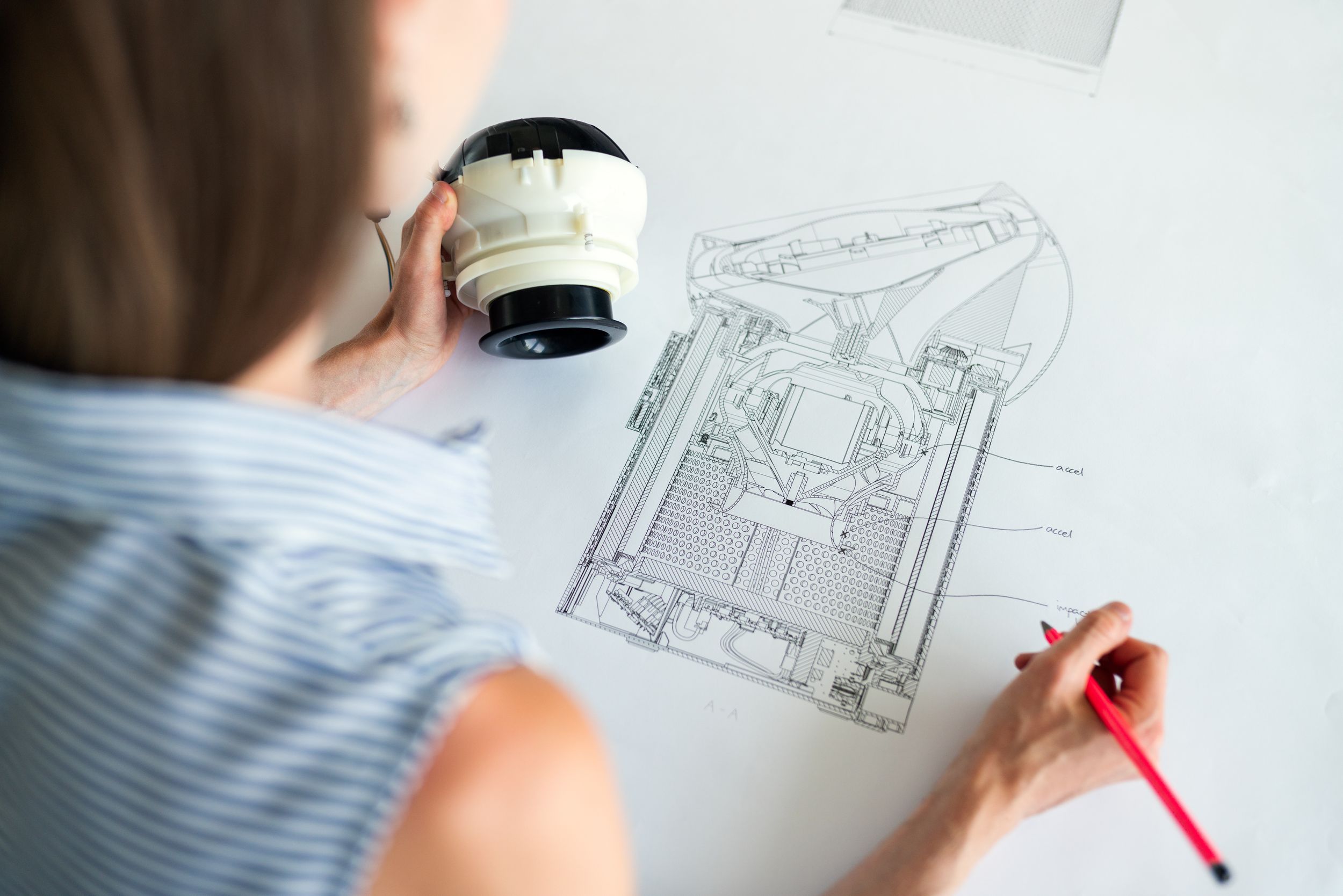 Woman engineer sketching a draft of an appliance.