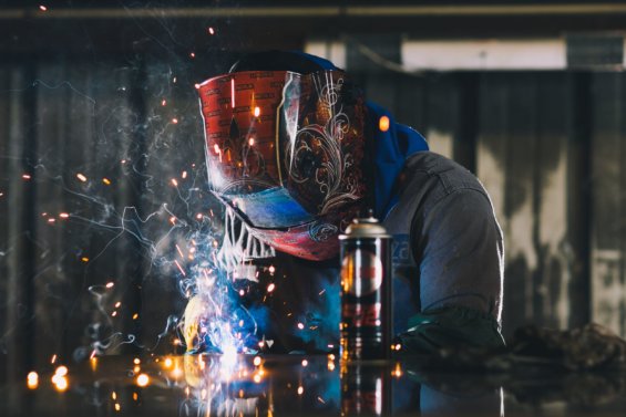 Person welding at Phoenix Metal Products.
