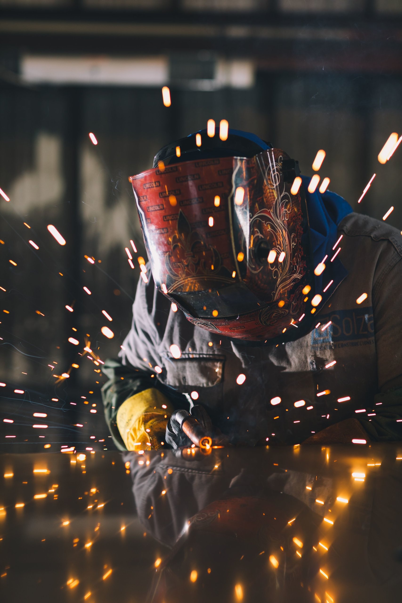 Person welding and sparks flying.